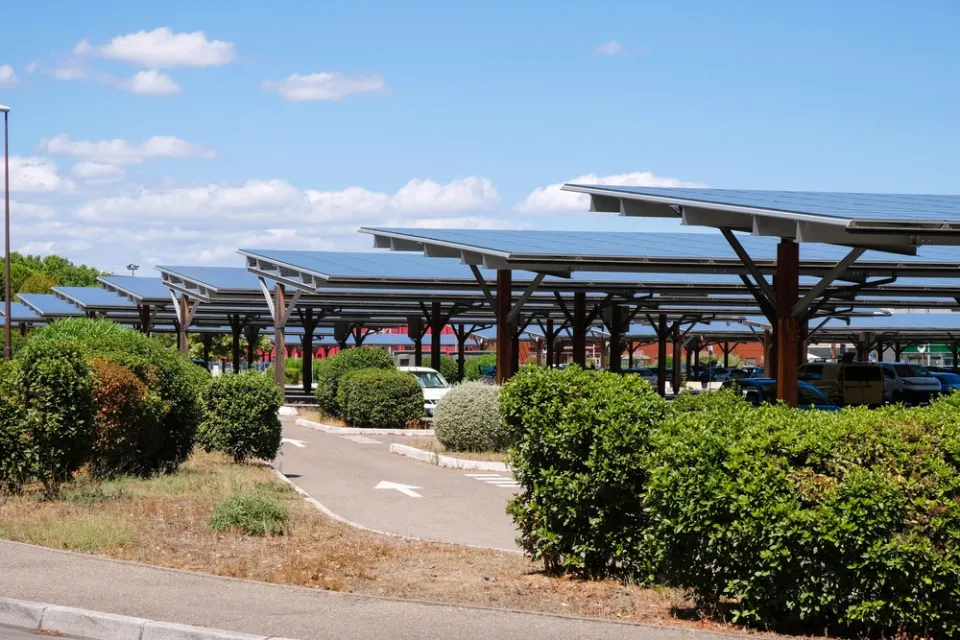 Solar panels shading cars in parking lot in Avignon, France